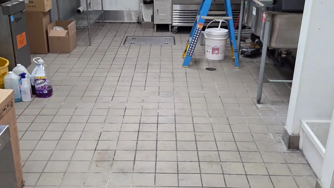 A commercial kitchen with its floor cleared