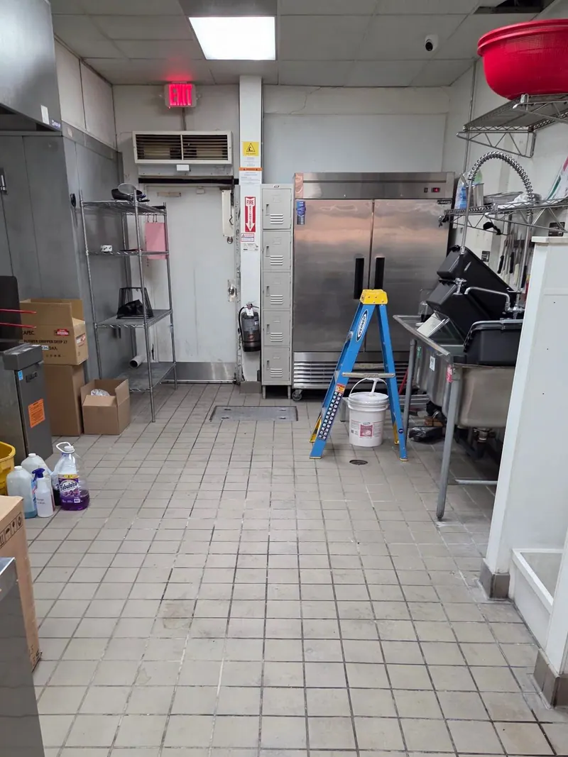 A commercial kitchen with its floor cleared