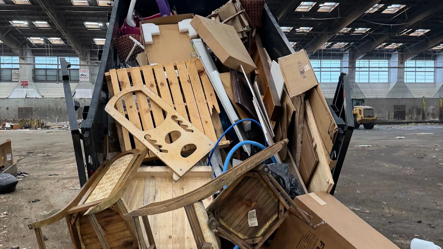 Cast Out dump trailer loaded with old chairs; wood furniture and boxes at the transfer station