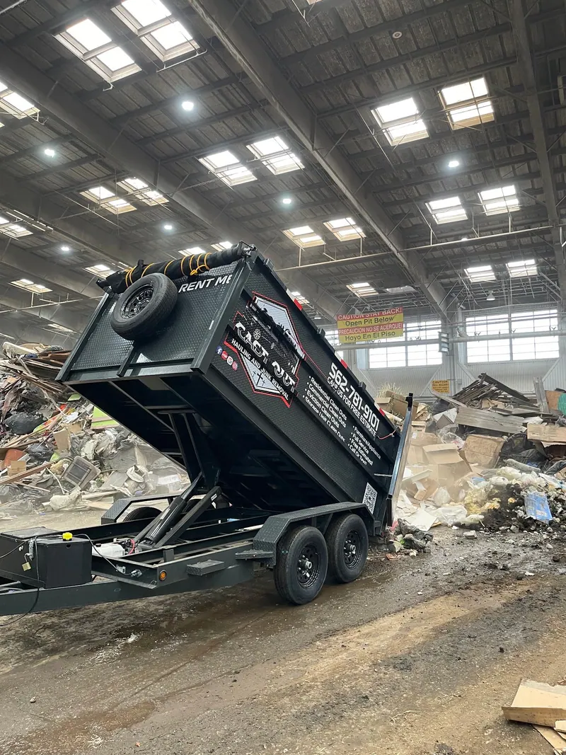 Cast Out hydraulic dump trailer tipping its load at the transfer station