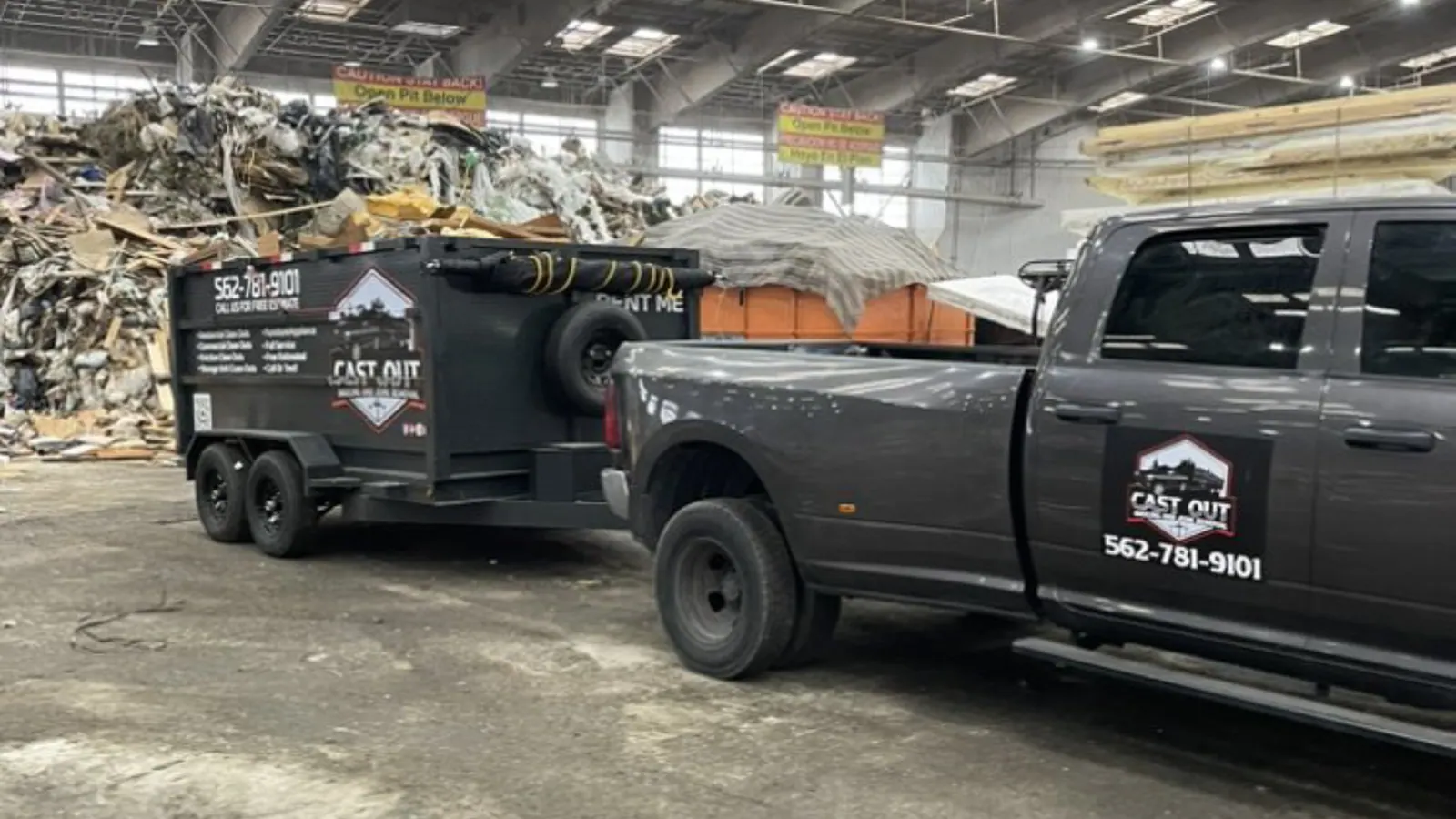 Cast Out pickup and loaded dump trailer parked in a transfer station unloading hall