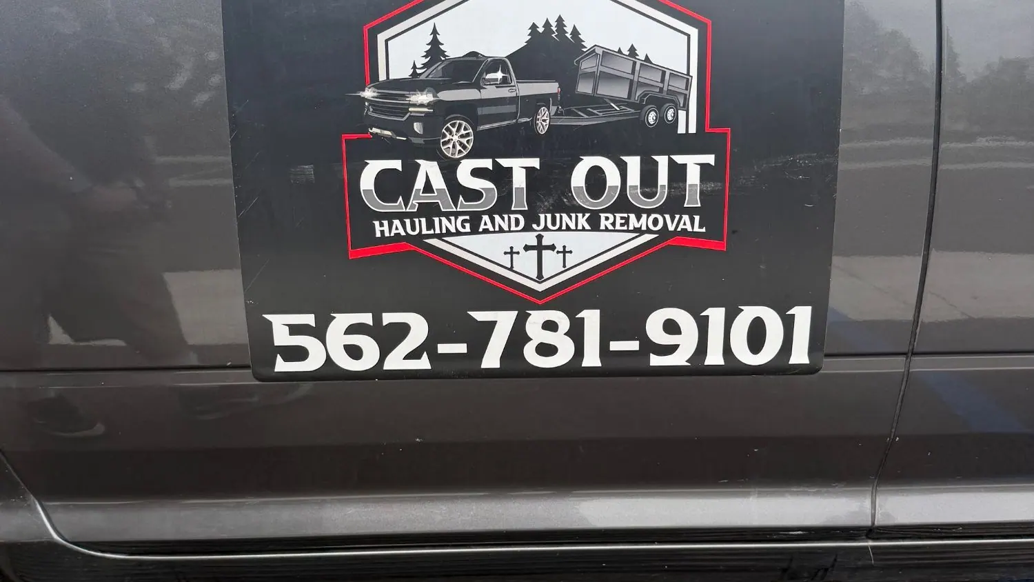 The Cast Out logo and phone number on the door of Louie's truck
