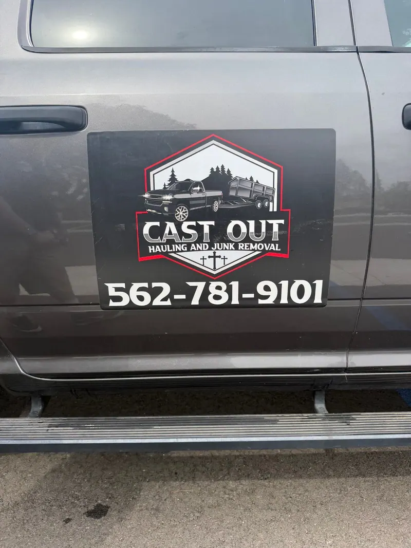 The Cast Out logo and phone number on the door of Louie's truck
